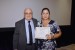 Dr. Nagib Callaos, General Chair, giving Mrs. Ariana Acon-Matamoros an award certificate in appreciation for his presentation oriented to inter-disciplinary communication entitled: "Processes of Information Analysis in the Academic Management of the State University at Distance (UNED) for Self-Evaluation in an Inter-Disciplinary Research."